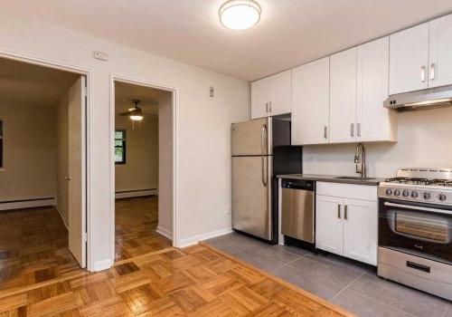2-bedroom unit with updated kitchen with white cabinets and open concept living and dining room.